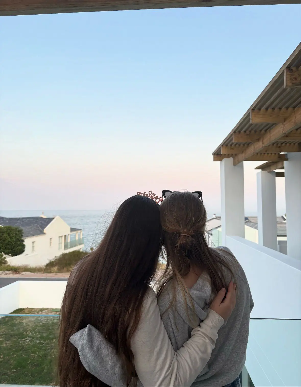 Image taken behind two women at Azure Horizons by the ocean.